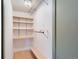 Walk-in closet with custom shelving and wood floor at 431 S Balsam St, Lakewood, CO 80226