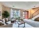 Cozy living room featuring neutral tones, plush seating, and large window with natural light at 431 S Balsam St, Lakewood, CO 80226