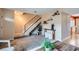 Bright living room with carpet, staircase, decorative shelves, and an open feel at 431 S Balsam St, Lakewood, CO 80226