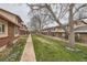 View of a tidy complex with sidewalks and mature trees at 431 S Balsam St, Lakewood, CO 80226