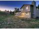 Sprawling fenced backyard with lush lawn, mature trees, deck and patio area at 8916 Sunridge Hollow Rd, Parker, CO 80134