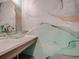 Stylish powder room with unique vessel sink and marble-inspired wallpaper at 8916 Sunridge Hollow Rd, Parker, CO 80134