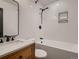 Cozy bathroom featuring a tub/shower combination with modern fixtures and a wood vanity at 8916 Sunridge Hollow Rd, Parker, CO 80134