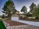 Charming two-story home featuring a brick and siding exterior with a two-car garage and a well-manicured front yard at 8916 Sunridge Hollow Rd, Parker, CO 80134