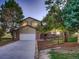 Charming two-story home featuring a brick and siding exterior with a two-car garage and a well-manicured front yard at 8916 Sunridge Hollow Rd, Parker, CO 80134