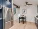 Modern kitchen with blue cabinets, stainless steel appliances, and a small seating area at 8916 Sunridge Hollow Rd, Parker, CO 80134