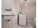Laundry room with patterned floor tile, white washer and dryer and vintage sink with black hardware at 8916 Sunridge Hollow Rd, Parker, CO 80134
