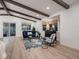 Bright living room with wooden beams, large windows, and modern decor at 8916 Sunridge Hollow Rd, Parker, CO 80134