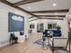 Bright living room with wooden beams, a shiplap accent wall, and large windows at 8916 Sunridge Hollow Rd, Parker, CO 80134