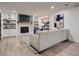 Modern living room with a fireplace, built-in shelves, and a large window offering natural light at 8916 Sunridge Hollow Rd, Parker, CO 80134