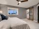 Comfortable bedroom with ceiling fan, sliding barn door, and a view of the outdoors at 8916 Sunridge Hollow Rd, Parker, CO 80134