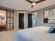 Serene bedroom with a sliding barn door to the bathroom, ceiling fan, and calming decor at 8916 Sunridge Hollow Rd, Parker, CO 80134