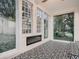 Sunroom with large windows, fireplace and decorative black and white patterned floor tiles at 8916 Sunridge Hollow Rd, Parker, CO 80134