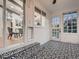 Sunroom featuring black and white patterned floor tiles with access to the dining room at 8916 Sunridge Hollow Rd, Parker, CO 80134