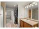 Bathroom featuring wood cabinets, a washer-dryer, and a glass-enclosed shower at 31719 Rocky Village Dr # 317, Evergreen, CO 80439