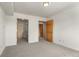 Bedroom with neutral walls, carpet, and direct access to bathroom and closet at 31719 Rocky Village Dr # 317, Evergreen, CO 80439