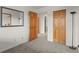 Bedroom features wood doors and access to a closet with a mirror at 31719 Rocky Village Dr # 317, Evergreen, CO 80439