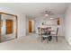 Open-concept dining area with a ceiling fan, neutral walls, and carpeted floors at 31719 Rocky Village Dr # 317, Evergreen, CO 80439