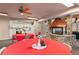 Dining area featuring a stone fireplace and access to the kitchen with white appliances at 31719 Rocky Village Dr # 317, Evergreen, CO 80439