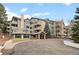 Inviting exterior of a multi-story condo building with stone accents and manicured landscaping at 31719 Rocky Village Dr # 317, Evergreen, CO 80439