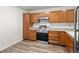 Bright kitchen with stainless steel appliances, light wood cabinets, and durable wood-look flooring at 31719 Rocky Village Dr # 317, Evergreen, CO 80439