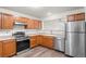 Well-lit kitchen with stainless steel appliances, light wood cabinets, and durable wood-look flooring at 31719 Rocky Village Dr # 317, Evergreen, CO 80439