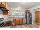 Open kitchen featuring stainless steel appliances, light wood cabinets, and wood-look flooring at 31719 Rocky Village Dr # 317, Evergreen, CO 80439