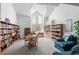 Well-lit library area featuring a large window, high ceilings, and ample shelving for book storage at 31719 Rocky Village Dr # 317, Evergreen, CO 80439
