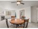 Bright living room with a fireplace, round table, and ceiling fan at 31719 Rocky Village Dr # 317, Evergreen, CO 80439