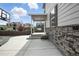 A spacious backyard featuring an expansive concrete patio, stone accents, and a privacy fence at 27504 E 1St Pl, Aurora, CO 80018