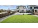 Expansive backyard with a lush green lawn, stone patio, basketball hoop, and trampoline at 27504 E 1St Pl, Aurora, CO 80018