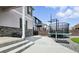 Spacious backyard featuring a large patio, basketball hoop, trampoline, and low maintenance gravel and synthetic lawn at 27504 E 1St Pl, Aurora, CO 80018