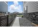 Narrow backyard space with a stone wall, privacy fence, trampoline, and landscaping at 27504 E 1St Pl, Aurora, CO 80018