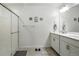 Modern bathroom featuring double sinks and a glass-enclosed shower at 27504 E 1St Pl, Aurora, CO 80018