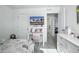 Bright bedroom with a white desk, gray carpet, and a television, designed to be a comfortable and functional space at 27504 E 1St Pl, Aurora, CO 80018