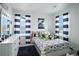 Bright bedroom with dinosaur-themed decor, striped curtains, and plenty of natural light at 27504 E 1St Pl, Aurora, CO 80018