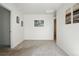 Bright bedroom featuring modern decor, neutral carpet, and a doorway leading to an adjacent room at 27504 E 1St Pl, Aurora, CO 80018