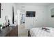 Bright bedroom with TV and ensuite bathroom at 27504 E 1St Pl, Aurora, CO 80018
