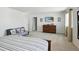 Comfortable bedroom with a large bed, dresser, mounted TV, and neutral decor with ample natural light at 27504 E 1St Pl, Aurora, CO 80018