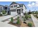 Charming two-story home with gray siding, stone accents, a two-car garage, and attractive landscaping at 27504 E 1St Pl, Aurora, CO 80018