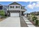 Charming two-story home with gray siding, stone accents, a two-car garage, and well-manicured landscaping at 27504 E 1St Pl, Aurora, CO 80018