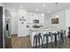 Modern kitchen with stainless steel appliances, granite countertops, white cabinetry, and a breakfast bar with stools at 27504 E 1St Pl, Aurora, CO 80018