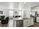 Open concept kitchen with stainless steel appliances, white cabinetry, and granite island at 27504 E 1St Pl, Aurora, CO 80018