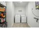 Functional laundry room with washer, dryer, and storage shelving at 27504 E 1St Pl, Aurora, CO 80018