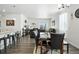 Open-concept living space with modern furnishings, dining area, and ample natural light from a large window at 27504 E 1St Pl, Aurora, CO 80018