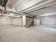 Spacious unfinished basement with concrete floors and exposed ceiling beams at 1102 Ridgefield Dr, Berthoud, CO 80513