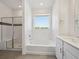Bright bathroom featuring a tub, a separate shower and a modern vanity with a sink at 1102 Ridgefield Dr, Berthoud, CO 80513