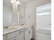 Bathroom with double vanity sinks and a tub with shower at 1102 Ridgefield Dr, Berthoud, CO 80513