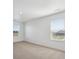 Bedroom featuring two windows and neutral colored carpet throughout at 1102 Ridgefield Dr, Berthoud, CO 80513