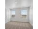 Bedroom featuring two windows and neutral colored carpet throughout at 1102 Ridgefield Dr, Berthoud, CO 80513